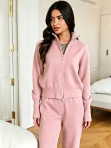 Close-up shot of the cozy pink zip-up knit cardigan and matching pants set for women.
