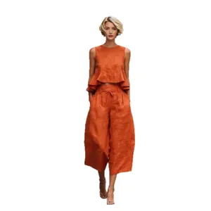 Women summer linen blend two piece set, orange sleeveless peplum top and wide leg pants.