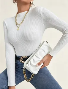 Close-up detail of women's white ribbed knit sweater featuring mock neck and slim fit design.