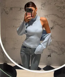 Light blue halter turtleneck knit sweater two-piece set, chic cutout sleeve detail.