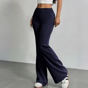 Detail view of women high waist dark blue casual flare pants worn by a model indoors.