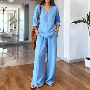 Casual women's light blue two-piece linen set with V-neck long sleeve top and wide leg pants.