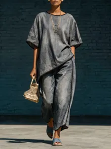 Detailed view of the stylish grey denim-style two-piece outfit featuring wide-leg pants.