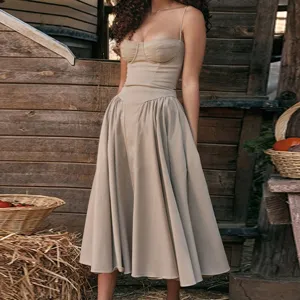 Detailed view of the beige corset midi dress featuring a strapless design and flared skirt.