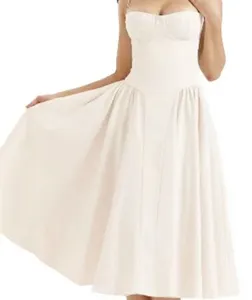 Detail shot of a cream strapless corset midi dress showcasing the fitted waist and flared skirt.