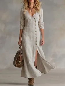 Detail view of casual linen long-sleeve maxi dress showcasing V-neck and front buttons.