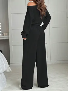 Detailed back view of women solid color off the shoulder long sleeve top and wide leg pants.