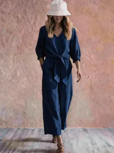 Casual V-neck tie waist jumpsuit with 3/4 sleeves, stylish resort wear outfit for women.