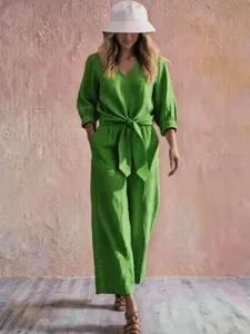 Green V-neck casual tie waist jumpsuit with three quarter sleeves for stylish spring vacation wear.
