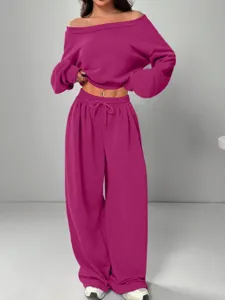 Detailed shot of the off-shoulder solid color sweatshirt and wide-leg pants set in casual style.