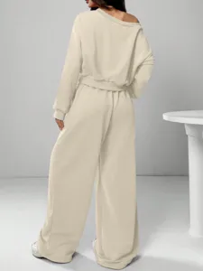 Detail view of women's off-the-shoulder sweatshirt and wide-leg pants set in solid beige.