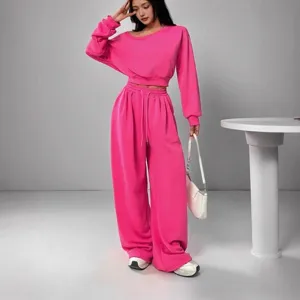 Women's casual hot pink two-piece tracksuit featuring an off-shoulder crop top and wide-leg pants.