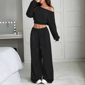 Casual solid color off shoulder long sleeve crop top and wide leg pants set for women.