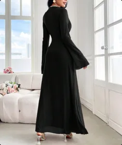 Detail view of the elegant black slim long sleeve dress with flare sleeves and maxi length.