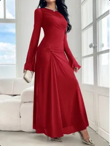 Details of the elegant red long sleeve slim trumpet dress with ruched design in bright room.