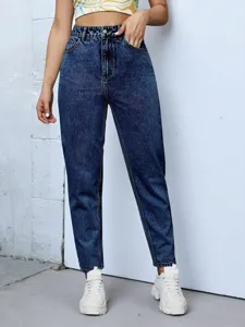 Close-up shot of women's high-waisted dark blue tapered jeans paired with casual outfit.