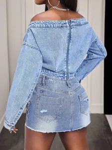 Detailed view of the stylish light blue denim off-the-shoulder top and matching skirt back zipper.