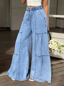 Detail view of womens light blue acid wash wide leg denim pants with elastic drawstring waist.