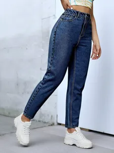 Detail view of high-waisted casual denim tapered pants, stylish everyday wear fit.