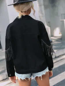 Detailed view of the black denim jacket featuring sparkling rhinestone fringe sleeves.
