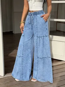Close-up detail view of light blue denim wide-leg pants with elastic drawstring waist.