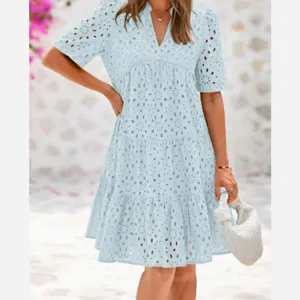 Close up detail of light blue eyelet embroidered tiered dress short sleeve V-neck summer casual style.