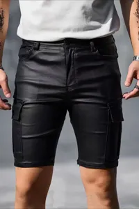 Close-up detail of mens black faux leather cargo shorts, slim fit summer half pants.