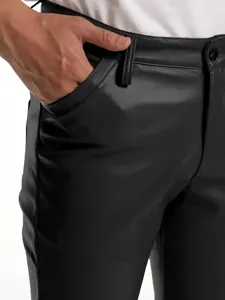 Close-up detail of men's slim black PU leather pants showing pocket and belt loop design.