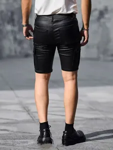 Close-up detail shot of men's black PU leather cargo shorts, slim fit, outdoor streetwear style.