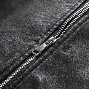 Black leather jacket metal zipper detail close-up view, fashionable slim fit women apparel.
