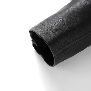 Close-up detail of black leather jacket sleeve showing fine texture and stitching craftsmanship.