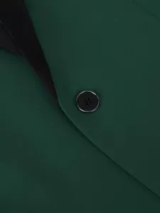 Green mens tuxedo jacket detail view showing black shawl lapel and button texture.