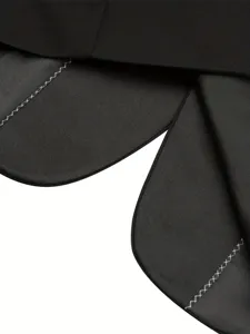 Black suit jacket lapel detail view showcasing elegant curved design and contrast stitching.