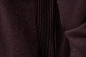 Close-up detail of dark purple men's knit sweater fabric showing fine ribbed and plain texture.