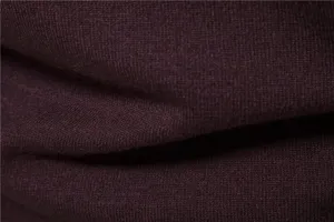 Close-up detail of thick warm men's knitted sweater fabric showing fine texture and cozy feel.
