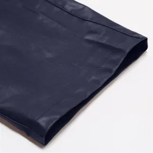 Close-up detail of dark blue PU leather men pants hem showing fine stitching and smooth texture.