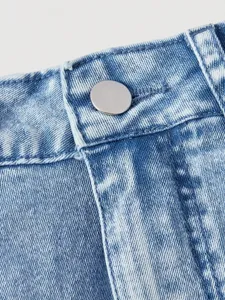 Close-up shot of denim skirt waistband with metallic button and fine stitching detail.