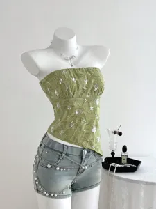 Detail view of the green sequin textured strapless tube top, featuring elegant summer style.