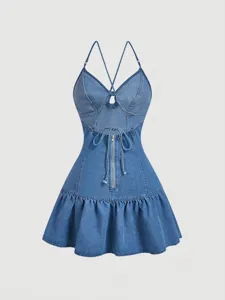 Detailed view of the blue denim halter dress featuring crisscross straps, front zipper, and ruffles.