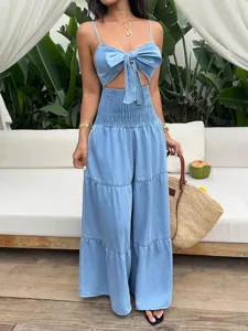 Summer light blue denim jumpsuit featuring a chic bow front, smocked waist, and stylish wide legs.