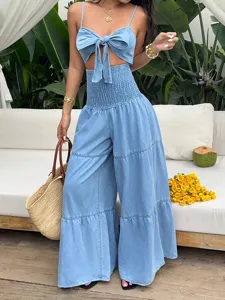 Denim crop top and wide leg pants set detail showing tie front bow and smocked high waist design.