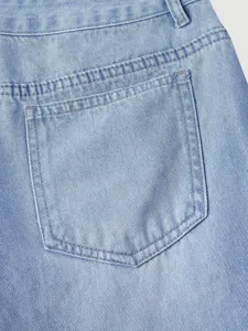 Close-up detail of light blue denim jeans back pocket featuring classic stitching and design.
