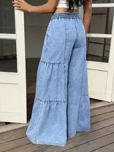 Detail view of women high waist elastic drawstring tiered wide leg light blue jeans.