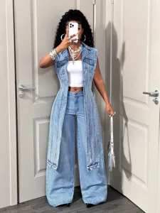 Detailed view of trendy front-long back-short denim vest outfit, casual street style apparel.