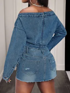 Detailed view of the back zipper and distressed denim fabric on the stylish top.