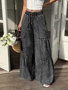 Womens high waist elastic drawstring wide leg denim pants detail view featuring trendy tiered panels.
