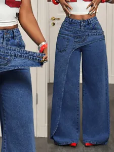 Detailed view of women high waist asymmetrical wide leg denim jeans, stylish blue long trousers.