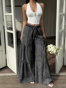 Detailed view of women's acid wash wide leg denim pants featuring a comfortable elastic drawstring waist.