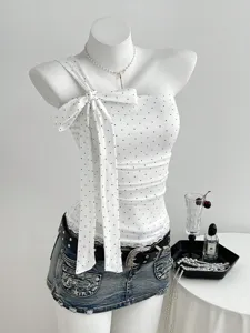 Detailed view of women sweet polka dot one shoulder bow strap top with denim mini skirt.