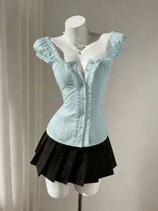 Close-up of a sweet light blue bubble sleeve blouse with delicate ruffles and front buttons.